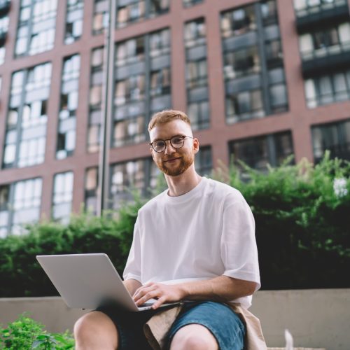 positive young freelancer working on laptop in cit 2026 01 09 07 09 11 utc